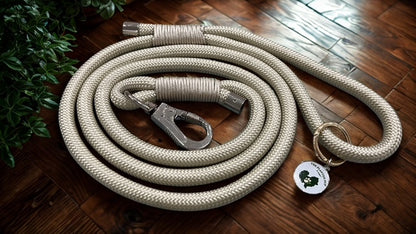 Khaki Dog leash with a clip and tag on a wooden floor