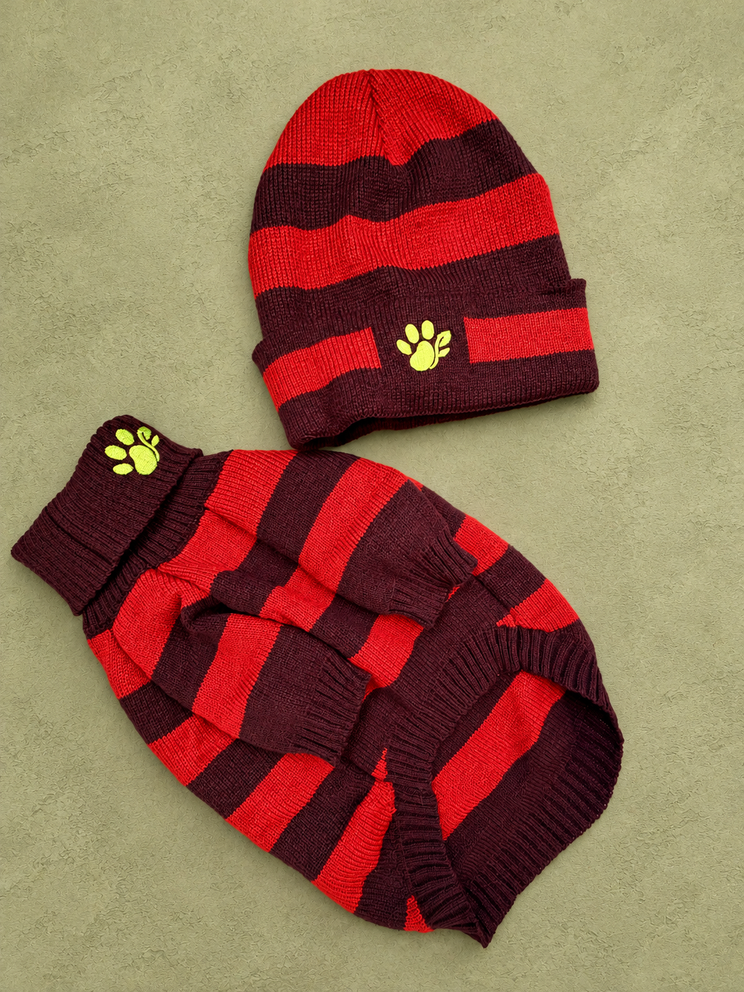 red/brown sweater and beanie on olive plaster